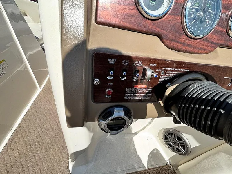 Slide: The Image of Control panel of a 2013 Sea Ray 240 Sundeck boat with gauges and switches. - 12