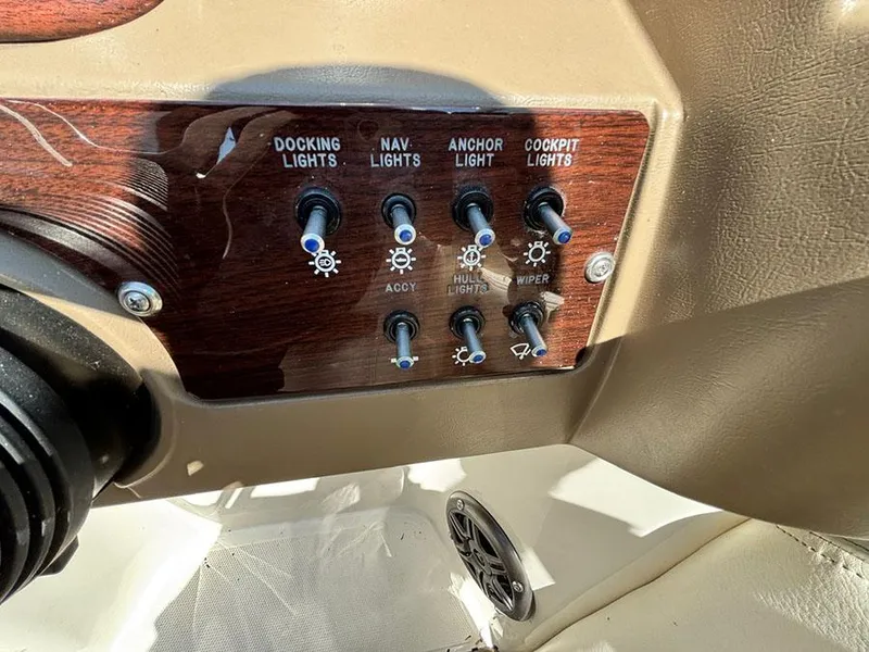 Slide: The Image of Control panel of a 2013 Sea Ray 240 Sundeck with various light switches. - 13