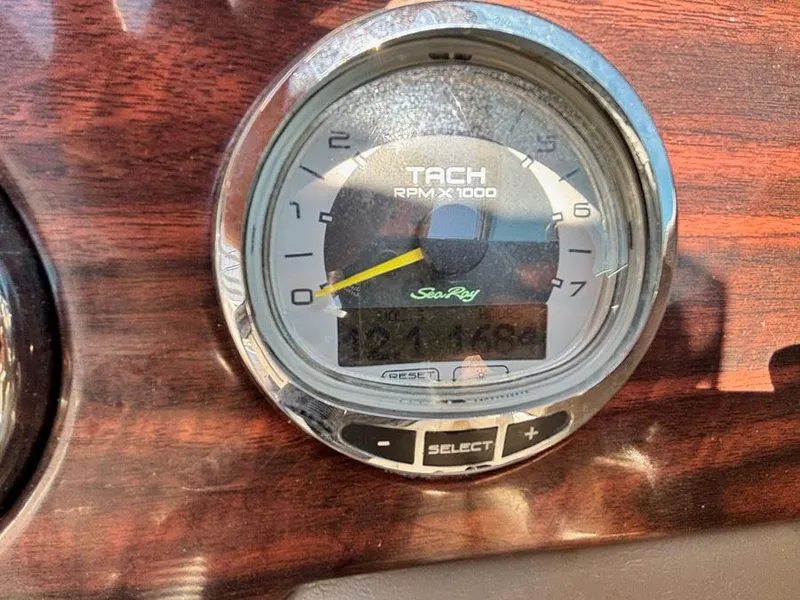 Slide: The Image of Tachometer of 2013 Sea Ray 240 Sundeck displaying RPM on wooden dashboard. - 15