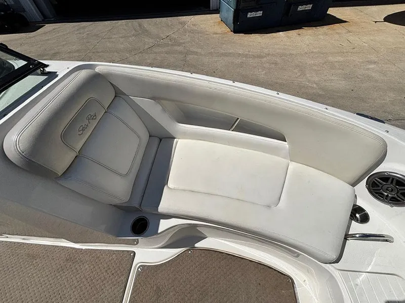 Slide: The Image of 2013 Sea Ray 240 Sundeck boat with white cushioned seating and speaker. - 20