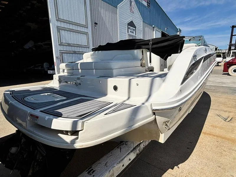 Slide: The Image of 2013 Sea Ray 240 Sundeck boat docked, featuring sleek design and spacious seating. - 5