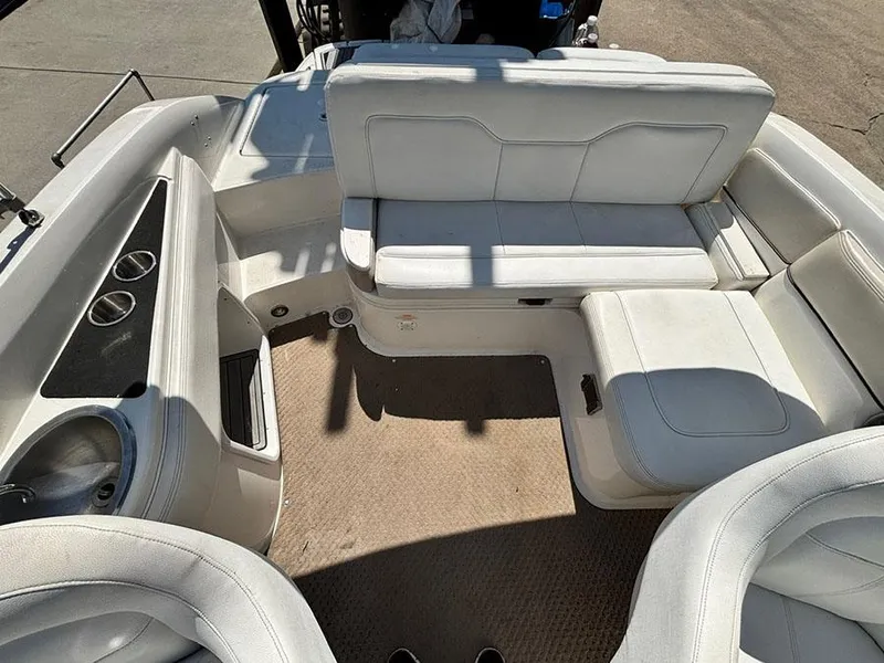 Slide: The Image of 2013 Sea Ray 240 Sundeck interior with white seating and cup holders. - 7