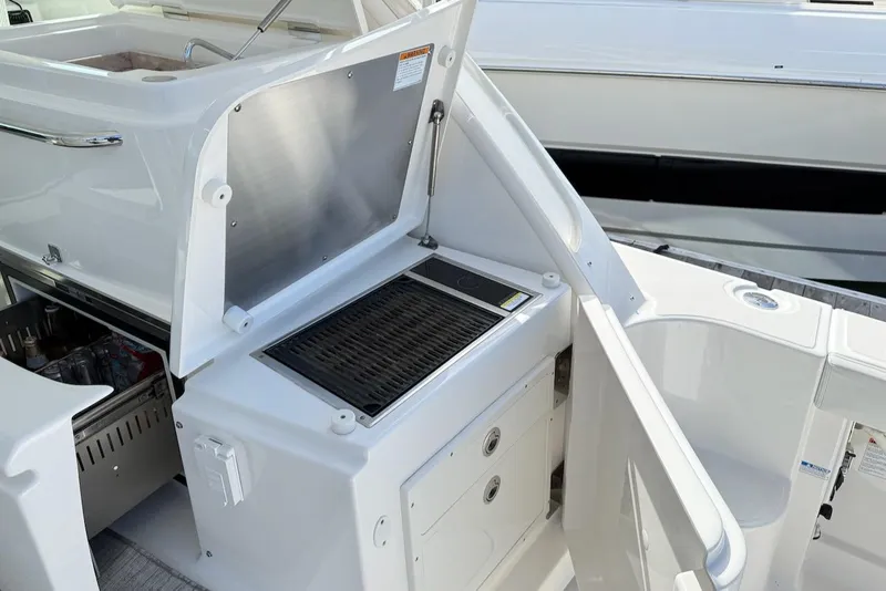 Slide: The Image of 2020 Tiara Yachts 3900 Open "Coronet" outdoor kitchen with grill and storage. - 11
