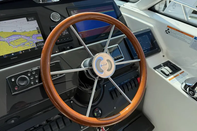 Slide: The Image of Steering wheel and dashboard of 2020 Tiara Yachts 3900 Open "Coronet" with navigation displays. - 19