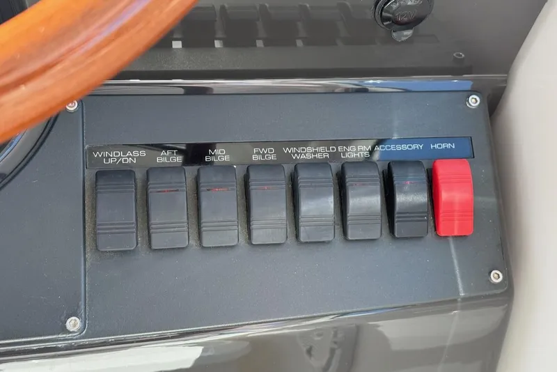 Slide: The Image of Control panel of a 2020 Tiara Yachts 3900 Open "Coronet" with labeled switches. - 24