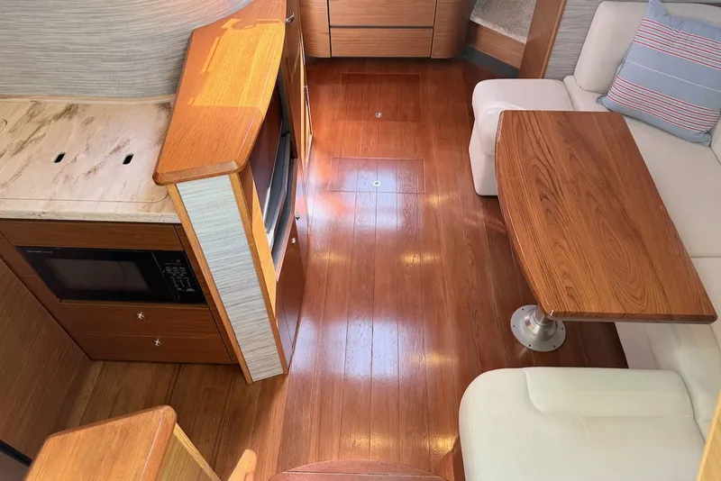Slide: The Image of Interior of 2020 Tiara Yachts 3900 Open "Coronet" with wood flooring and modern furnishings. - 25