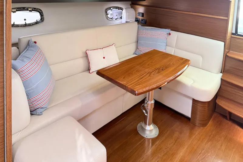 Slide: The Image of Luxurious interior of 2020 Tiara Yachts 3900 Open "Coronet" with elegant seating and wooden table. - 29