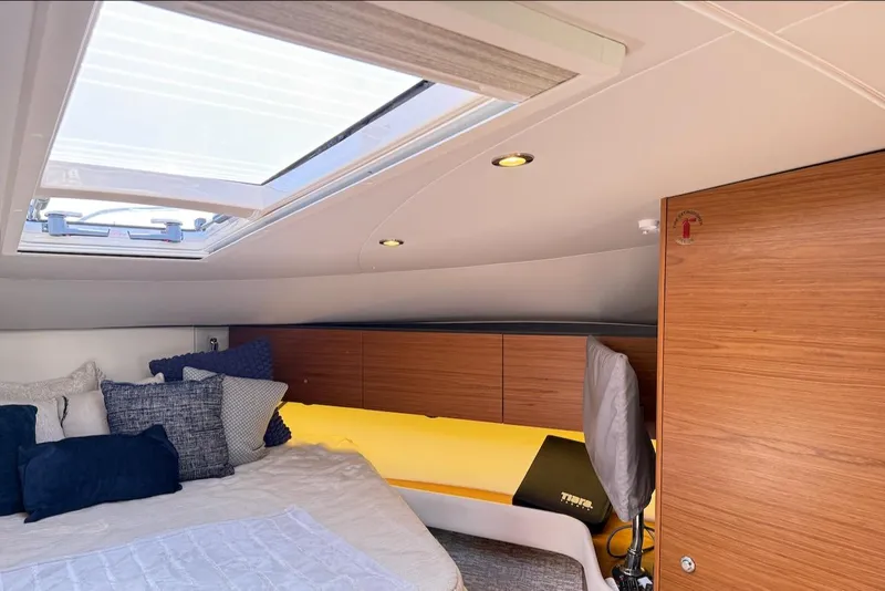 Slide: The Image of 2020 Tiara Yachts 3900 Open "Coronet" cabin interior with skylight and cozy bedding. - 43