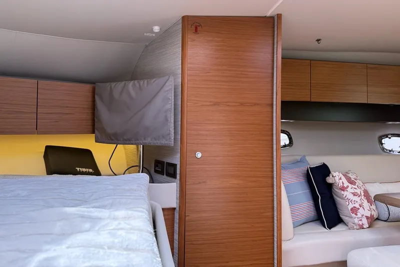 Slide: The Image of 2020 Tiara Yachts 3900 Open "Coronet" interior with wood paneling and cozy seating. - 44