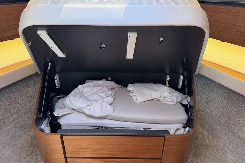 Slide: The Image of Under-seat storage compartment in 2020 Tiara Yachts 3900 Open "Coronet" with white linens. - 47