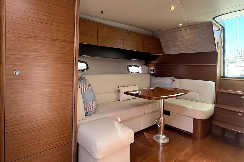 Slide: The Image of 2020 Tiara Yachts 3900 Open "Coronet" interior with elegant seating and wooden finishes. - 48