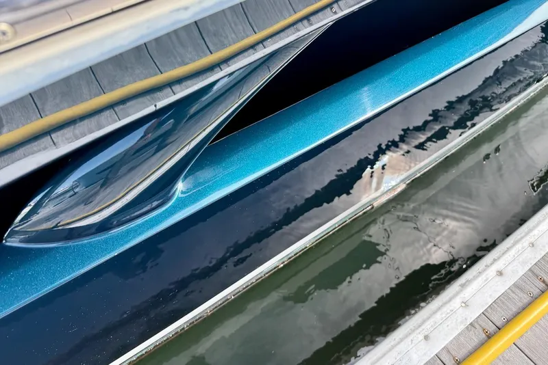 Slide: The Image of 2020 Tiara Yachts 3900 Open "Coronet" hull reflecting on water at dock. - 49
