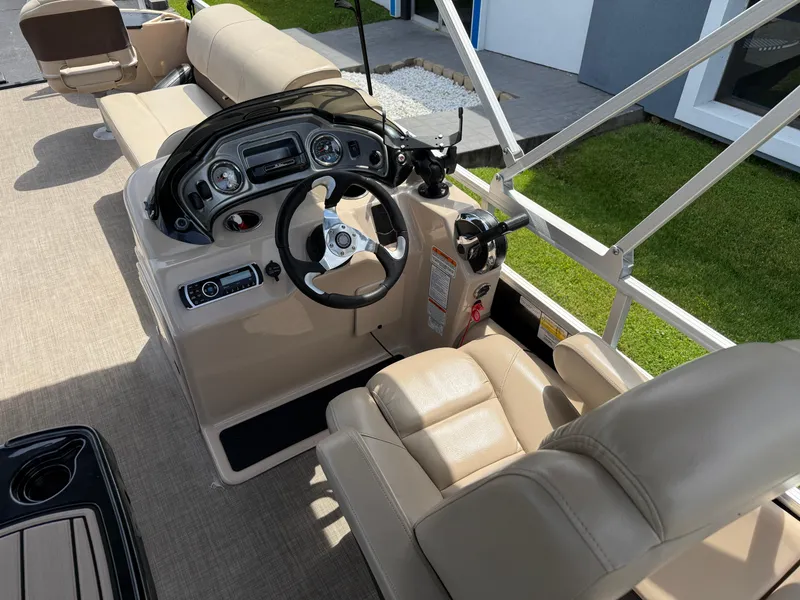 Slide: The Image of 2019 Sun Tracker Fishin' Barge 24 DLX boat interior with steering console and seating. - 10