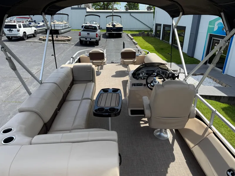 Slide: The Image of 2019 Sun Tracker Fishin' Barge 24 DLX interior with seating and steering console. - 13