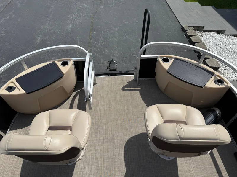 Slide: The Image of 2019 Sun Tracker Fishin' Barge 24 DLX interior with beige seating and fishing stations. - 16