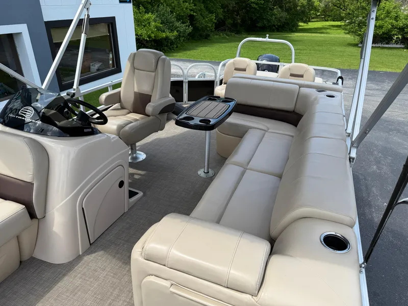 Slide: The Image of 2019 Sun Tracker Fishin' Barge 24 DLX interior with beige seating and steering console. - 8