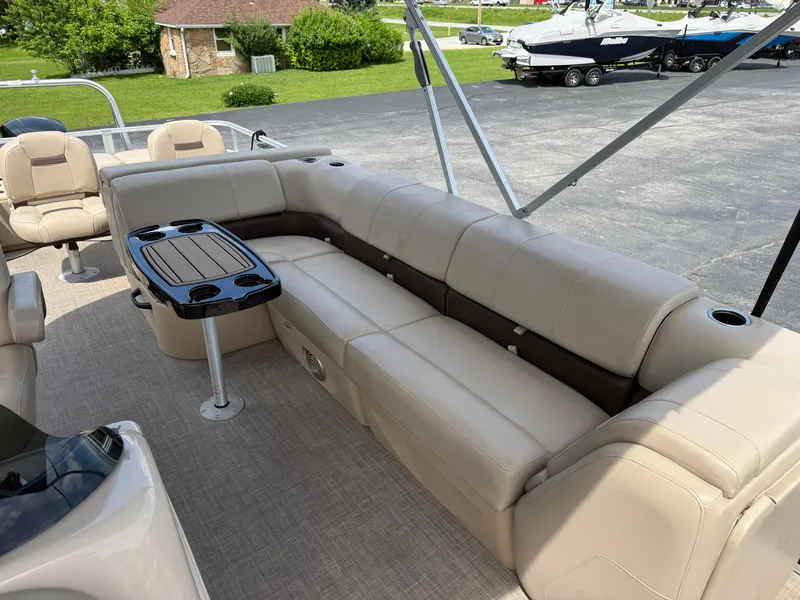 Slide: The Image of 2019 Sun Tracker Fishin' Barge 24 DLX with beige seating and a central table. - 9