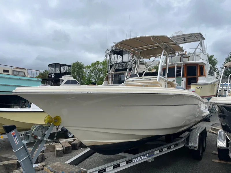 Slide: The Image of 2020 Scout 215 XSF boat on trailer, parked in marina with overcast sky. - 0
