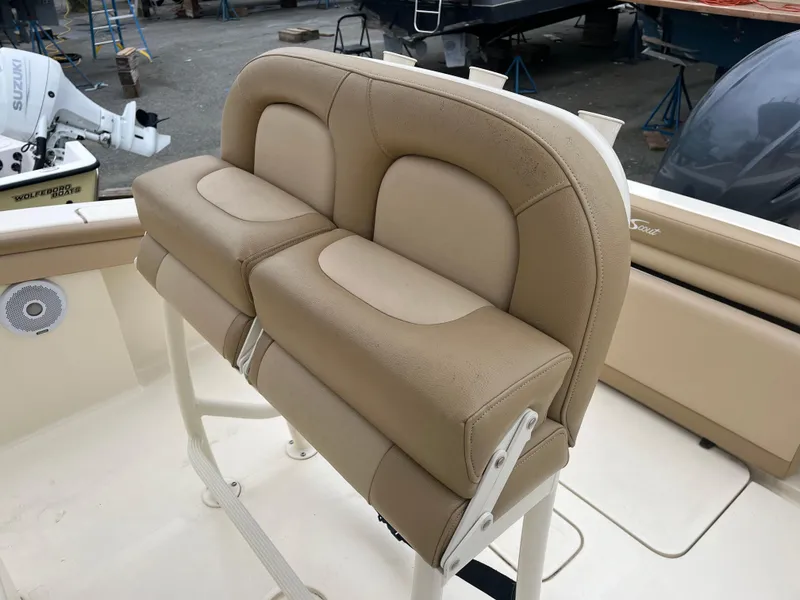 Slide: The Image of 2020 Scout 215 XSF boat with beige cushioned seating and marine equipment. - 10