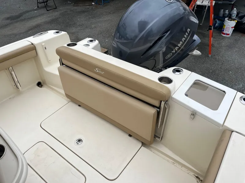 Slide: The Image of 2020 Scout 215 XSF boat interior with Yamaha engine, featuring beige seating and cup holders. - 11