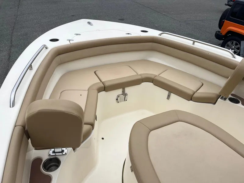 Slide: The Image of 2020 Scout 215 XSF boat with beige seating and stainless steel railings. - 13