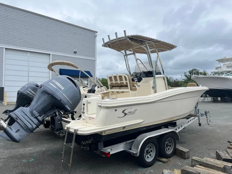 Slide: The Image of 2020 Scout 215 XSF boat on trailer with Yamaha engines, parked outdoors. - 2