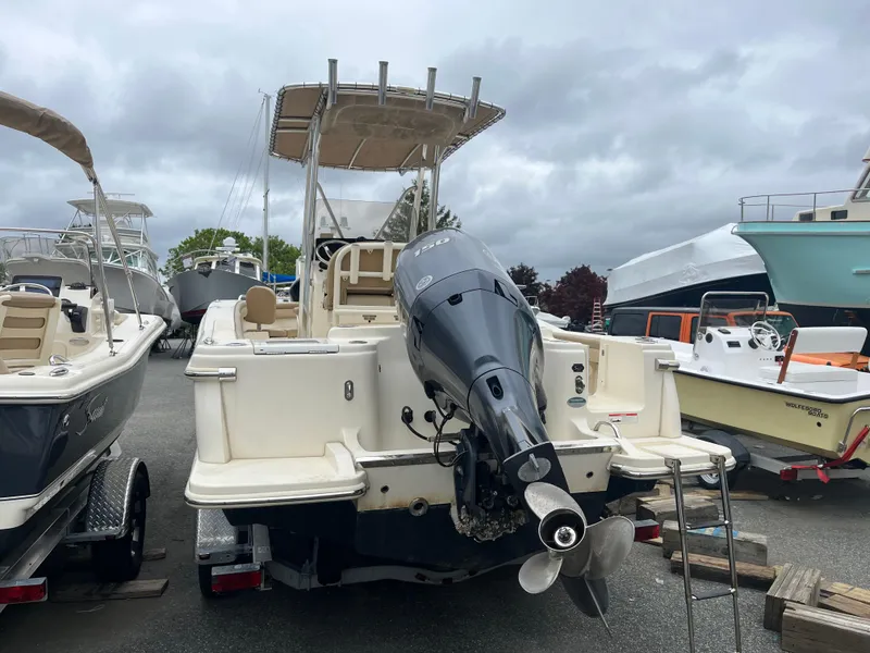 Slide: The Image of 2020 Scout 215 XSF boat with outboard motor, parked in a marina. - 3