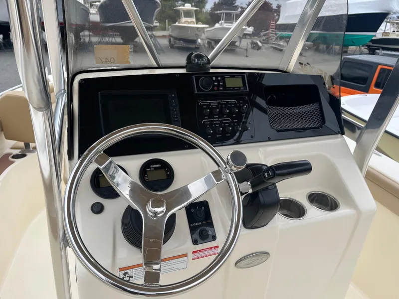 Slide: The Image of 2020 Scout 215 XSF boat dashboard with steering wheel and control panel. - 6