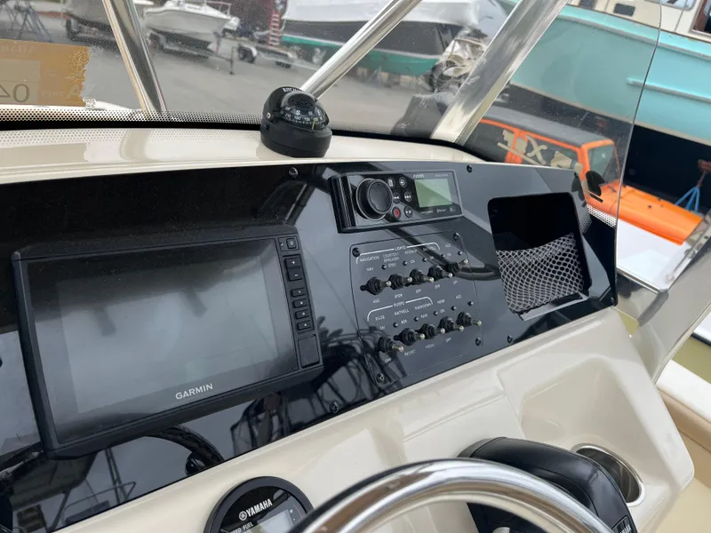 Slide: The Image of 2020 Scout 215 XSF boat dashboard with Garmin navigation system and controls. - 7