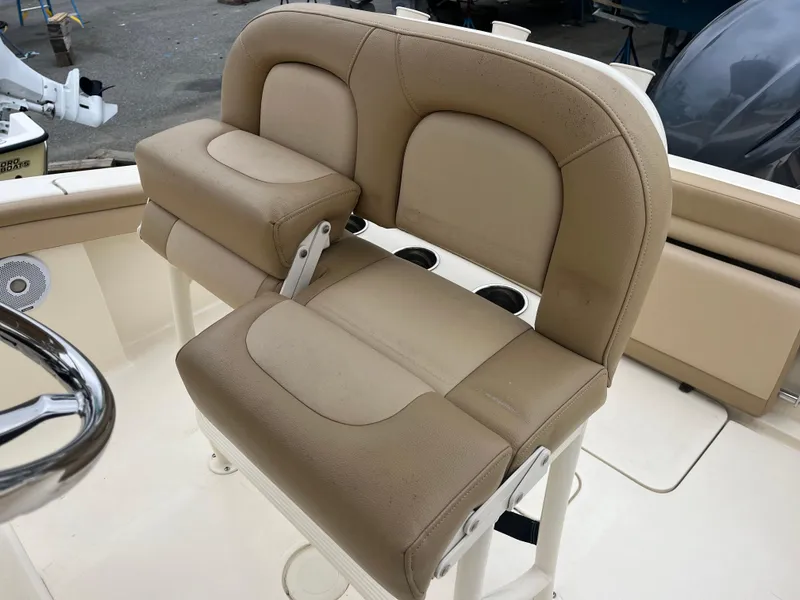 Slide: The Image of 2020 Scout 215 XSF boat seating with beige upholstery and armrest. - 9