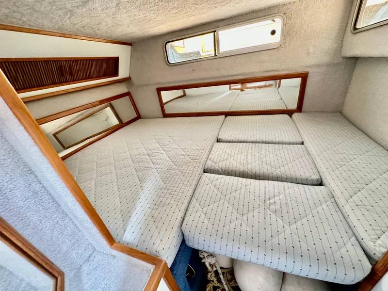 Slide: The Image of Interior cabin of 1987 Sea Ray 270 Sundancer with cushioned sleeping area. - 18