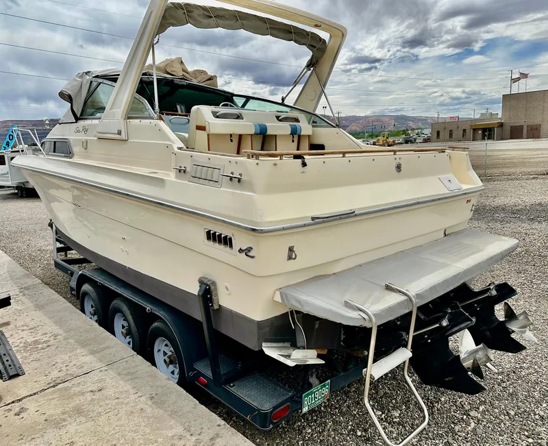 Slide: The Image of 1987 Sea Ray 270 Sundancer boat on trailer, rear view, parked outdoors. - 7