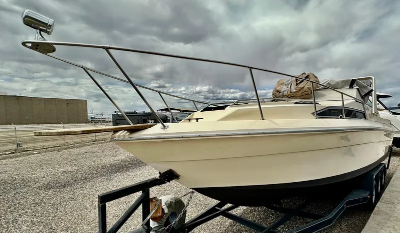 Slide: The Image of 1987 Sea Ray 270 Sundancer boat on trailer under cloudy sky. - 8