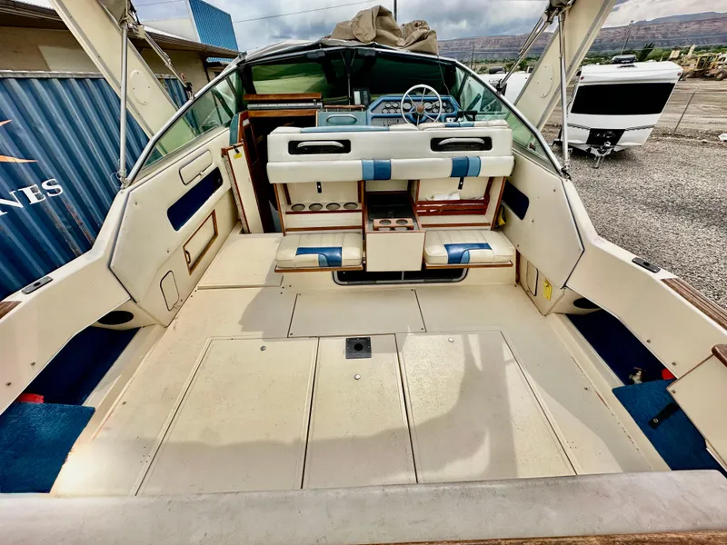 Slide: The Image of 1987 Sea Ray 270 Sundancer boat interior with seating and steering wheel. - 9
