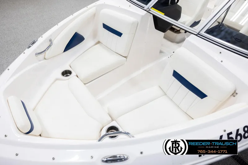 Slide: The Image of 2008 Regal 1900 boat interior with white seating and blue accents. - 10