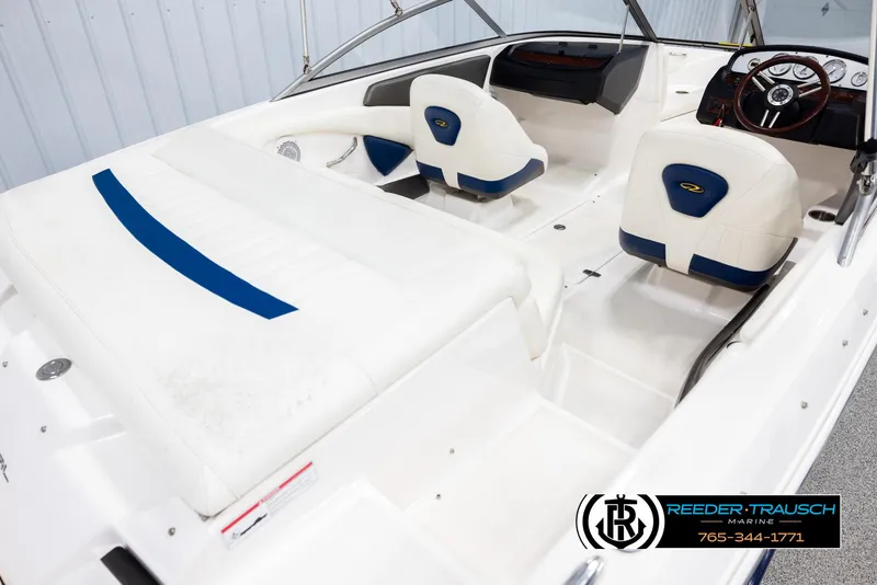 Slide: The Image of 2008 Regal 1900 boat interior with white and blue seating, steering wheel, and dashboard. - 12