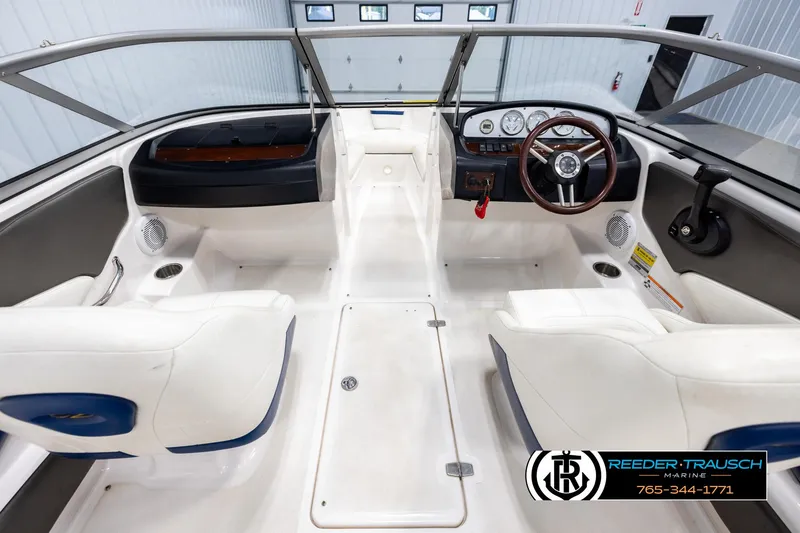 Slide: The Image of Interior of a 2008 Regal 1900 boat with white seating and steering wheel. - 14