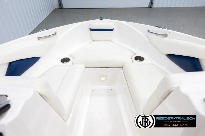 Slide: The Image of Interior of a 2008 Regal 1900 boat with white seating and cup holders. - 15