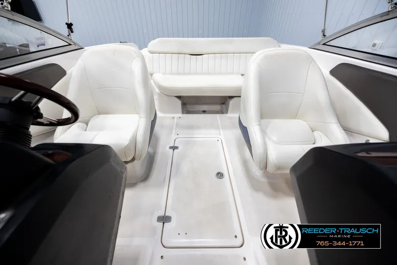 Slide: The Image of Interior of a 2008 Regal 1900 boat with white seating and steering wheel. - 18