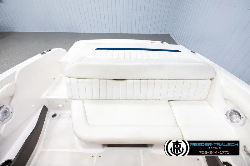 Slide: The Image of 2008 Regal 1900 boat interior with white seating and logo. - 19