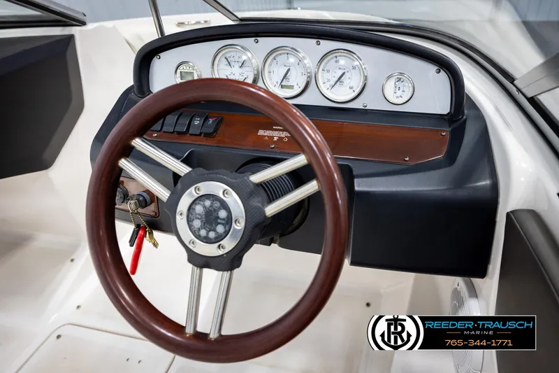 Slide: The Image of Steering wheel and dashboard of 2008 Regal 1900 boat with gauges and controls. - 23