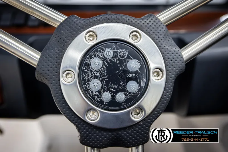 Slide: The Image of Steering wheel of 2008 Regal 1900 boat with control buttons and logo. - 25