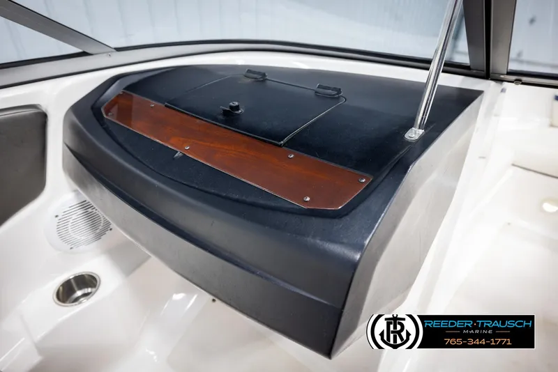 Slide: The Image of 2008 Regal 1900 boat dashboard with storage compartment and speaker. - 31