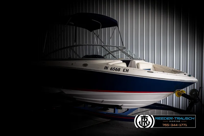 Slide: The Image of 2008 Regal 1900 boat in storage, featuring a sleek design and blue accents. - 4