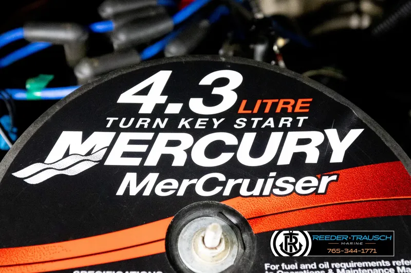Slide: The Image of 4.3 Litre Mercury MerCruiser engine cover with branding and contact details. - 40