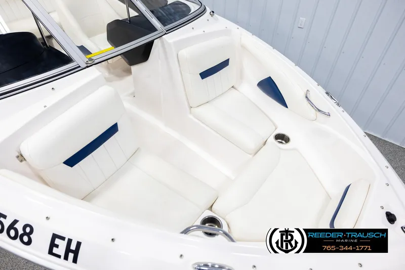 Slide: The Image of 2008 Regal 1900 boat interior with white seating and blue accents. - 9