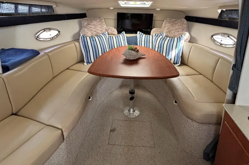 Slide: The Image of Luxurious interior of 2006 Bayliner 325 yacht with beige seating and striped pillows. - 14