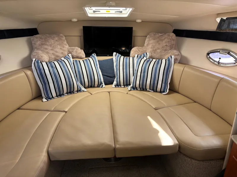 Slide: The Image of Luxurious interior of 2006 Bayliner 325 with plush seating and striped cushions. - 15