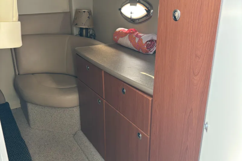 Slide: The Image of Interior of 2006 Bayliner 325 boat with seating and storage cabinets. - 19