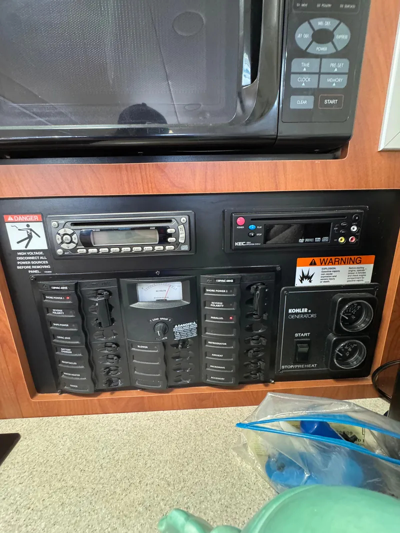 Slide: The Image of Control panel of a 2006 Bayliner 325 boat with microwave and warning labels. - 22